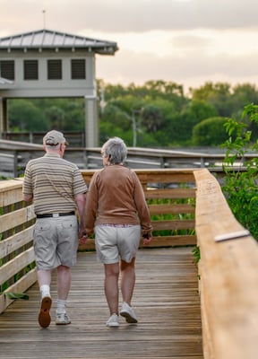 Older couple walking on a Florida boardwalk