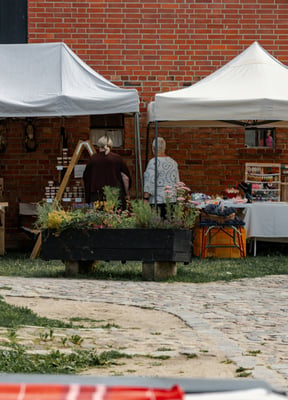 Rustic brick building with outdoor market stalls