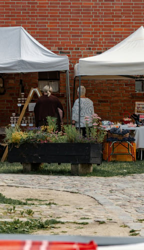 Rustic brick building with outdoor market stalls